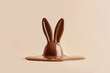 Melt chocolate bunny on beige background. Easter minimal concept.