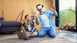 © gorynvd - Happy young father and son testing vr goggles playing augmented video reality games.