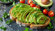 Sliced avocado toast garnished with cilantro and cherry tomatoes