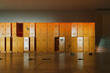 Sunlit Empty School Corridor with Colorful Lockers and Debris