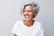Portrait of happy senior woman with grey hair and white t-shirt