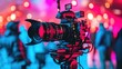 Professional video camera on a film set with colorful bokeh lights in the background.