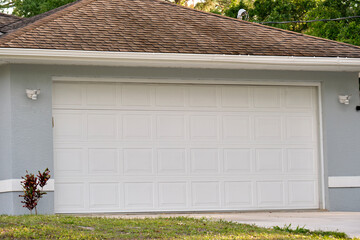 Wall Mural - Wide garage double door and concrete driveway of new modern american house