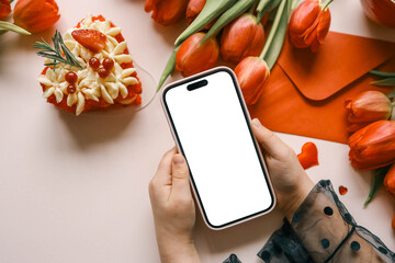 Wall Mural - Girl with a phone in her hands with an isolated screen on a background of flowers