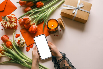 Wall Mural - Candle and bouquet of red tulips, spring aesthetics