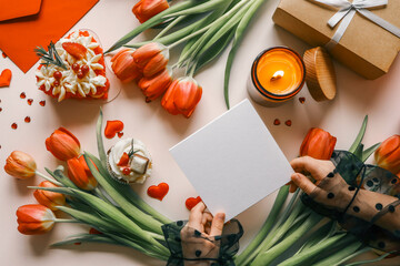 Wall Mural - Sheet of paper in hands on a background of spring flowers