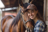 Fototapeta  - Horse and rider caretaker, young woman smiling as she is a worker and farmer in a stable with equine animals