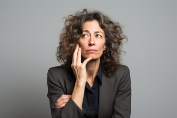 Poster - Middle age business woman with surprise and shocked facial expression on grey background