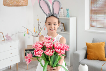 Poster - Cute little girl with bunny ears and tulip flowers at home