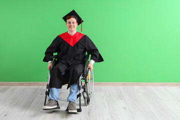 Poster - Male graduate in wheelchair near green wall