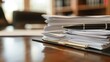 A stack of papers sits on a desk next to a closed folder marked Merger Acquisition Legal Support representing the thorough and meticulous work required for navigating legal