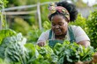 A plus-size African American woman tends to her garden, harvesting leafy greens. Perfect for sustainability and healthy lifestyle concepts.