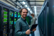 © MVProductions - Portrait of IT Specialist Uses tablet in Data Center. Server Farm Cloud Computing Facility with Male Maintenance Administrator Working. Cyber Security and Network Protection