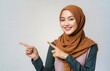 Happy Moslem Young South East Asia Woman:  Beautiful Southeast Asia woman with earth tone hijab smiling pointing hands to right