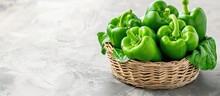 Green Bell Pepper Or Capsicum In A Basket On A White Background.