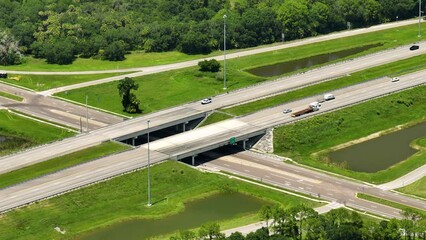 Poster - Aerial view of highway overpass with moving traffic cars and trucks
