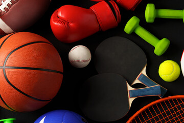 Wall Mural - Various sports equipment on black background studio shot