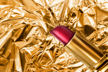 Wall Mural - Red lipstick on golden foil