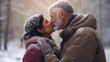 © shelbys - elder indian couple sharing a kiss while standing in snowy nature background.
