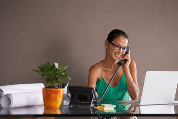 Wall Mural - Phone call, remote work and landline with receptionist woman in office for communication or reception. Laptop, smile and happy young woman answering telephone in small business or startup workplace