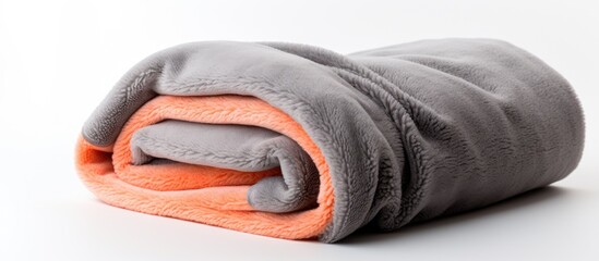 Poster - Cozy Grey and Orange Blanket Carefully Arranged on a Clean White Surface