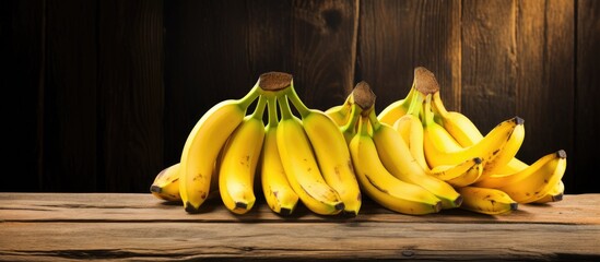 Poster - Fresh Ripe Bananas Arranged on a Rustic Wooden Table in Natural Sunlight