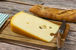 fromage, tranche de Maasdam, en gros plan, sur une planche à découper	