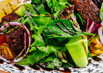 Wall Mural - healthy green salad on plate close up