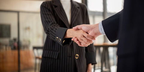 Wall Mural - Handshake of two business people after contract agreement to become a partner, collaboration teamwork