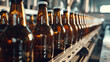Row of beer bottles on a conveyor belt in a brewery production line.
