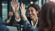 © Michael - Businesswoman giving a high five to a colleague in meeting