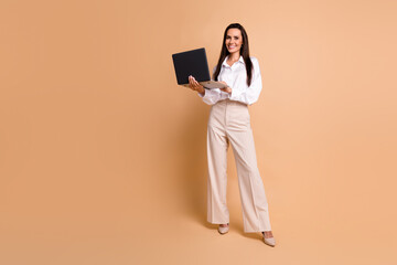 Poster - Full body photo of lovely elegant lady use wireless laptop networking empty space isolated on beige color background