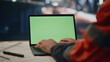 © stockbusters - Factory worker typing green screen laptop on plant workshop close up. Engineer