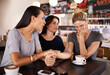 © Hover/peopleimages.com - Friends, coffee and sad woman in cafe for support in mental health, counselling and help for stress. Restaurant, trust and group of women holding hands or talking for comfort, empathy or bad news