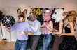 © PintoArt - Group of Friends in Animal Masks Celebrating at a Party