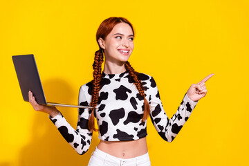 Photo of dreamy thoughtful woman wear cow skin print top texting modern gadget showing empty space isolated yellow color background