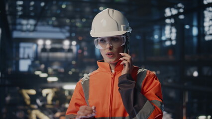 Poster - Engineer have work call at modern factory facility in protective hardhat closeup