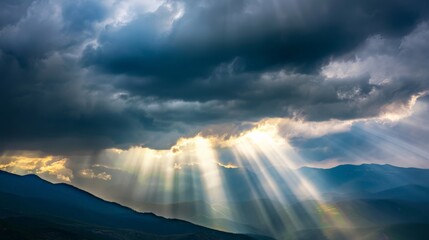 Wall Mural - Rays of light shining through dark clouds It's gonna rain, dramatic sky with cloud, Sky background on sunrise nature composition The beam of light through the dark clouds on the mountains.