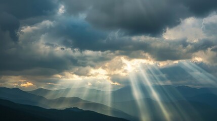 Wall Mural - Rays of light shining through dark clouds It's gonna rain, dramatic sky with cloud, Sky background on sunrise nature composition The beam of light through the dark clouds on the mountains.