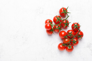 Wall Mural - Cherry tomatoes on branches with copy space on white background, top view