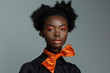satin or silk orange scarf tied in a bow around the neck of a black model