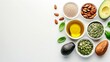 Assorted healthy fats selection with avocado, nuts, seeds, and olive oil, with copy space for text.