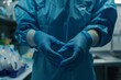 Close up of surgeon's hands with blue nitrile gloves on