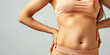 Close-up of a female belly slim beautiful, copy space. Losing weight, a course of exercises for tummy tuck.
