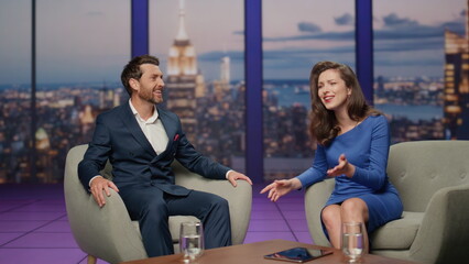 Tv show presenter interviewing man guest in modern television channel studio