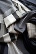 background of gray black and white fabrics of different textures and patterns. Fabrics for sewing a men's classic suit. Wedding preparations. Materials for seamstress.