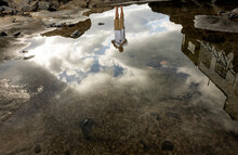 Upside-down Reflection Of Man In A Puddle