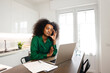 © Mia_Bon - An African American woman with glasses on her hair and massages her head feeling drained at home office working