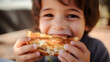 Close-up of a child enjoying a gooey grilled cheese sandwich,