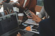 © Sirikarn Rinruesee - Business team meeting working with new startup project, discussion and analysis data the charts and graphs. Digital tablet, calculator, laptop computer using, Business finance and accounting concept.